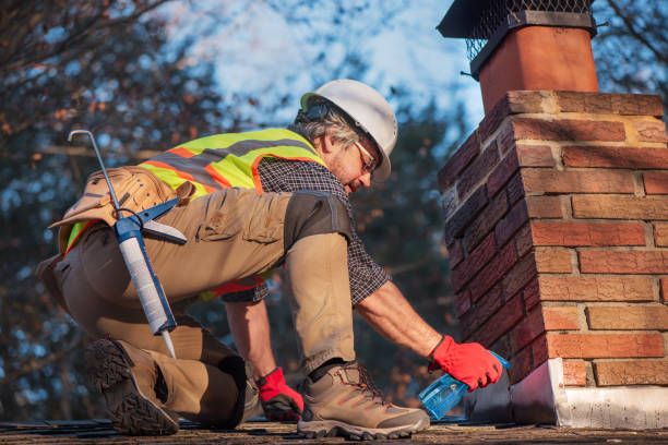 Technician sealing chimney flashing to stop a roof leak in Minneapolis